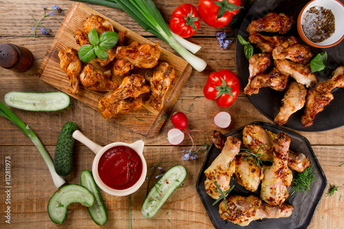 Grilled sausage, chicken leg and wings with vegetables