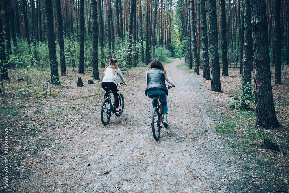 Woman riding a mountain bike in the forest.