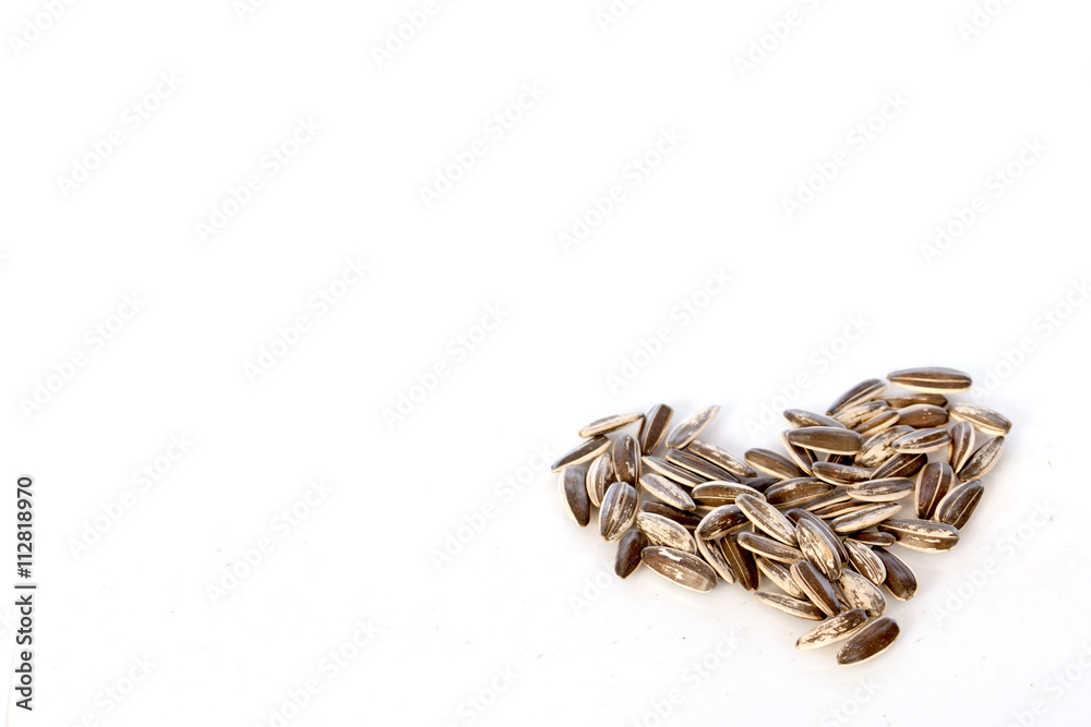 Sunflower seeds on white background , selective focus Sunflower seeds on white background , selective focus