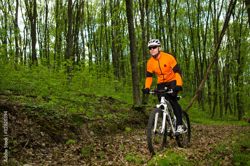 Cyclist Riding the Bike in Beautiful Spring Forest © Aleksey