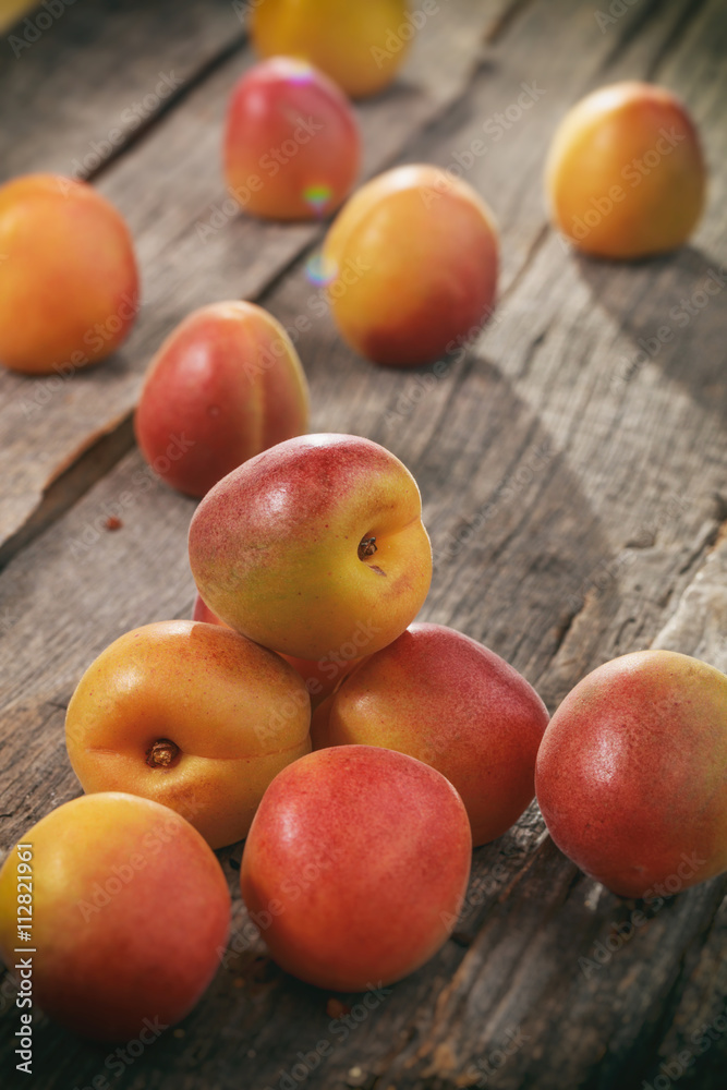 Bunch of apricots, on wooden surface.