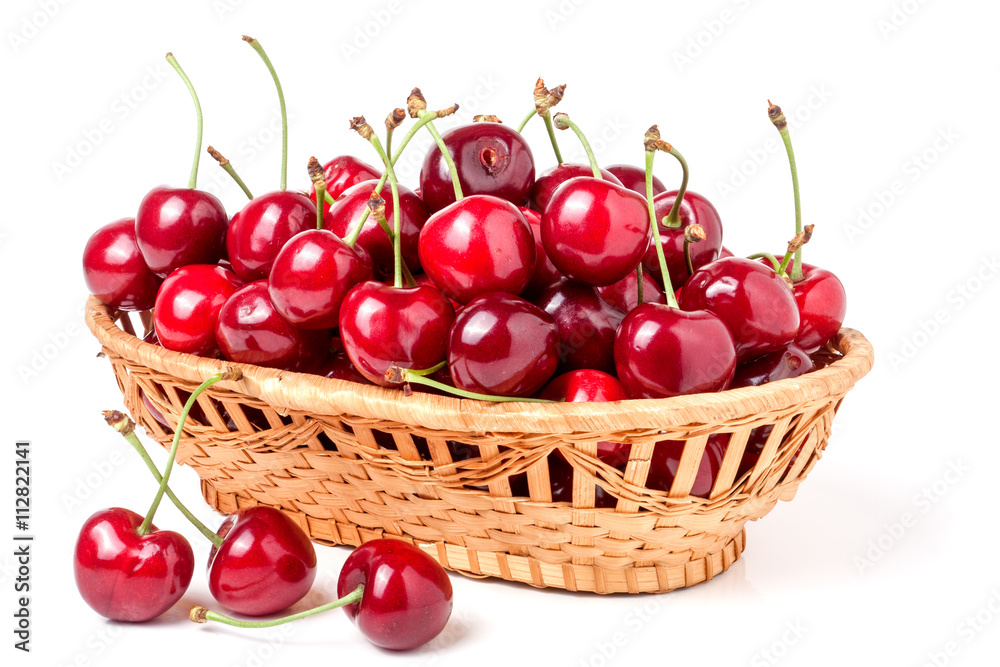 cherries in a wicker basket isolated on white background cherries in a wicker basket isolated on white background