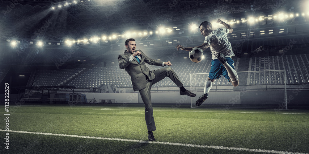 Businessman and player fighting for ball
