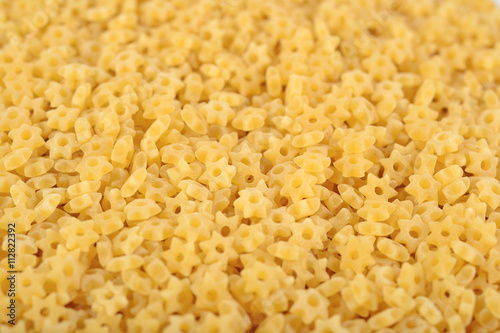 Uncooked italian pasta stars as background