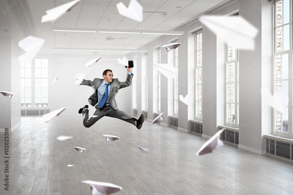 Fototapeta premium Dancing businessman in office