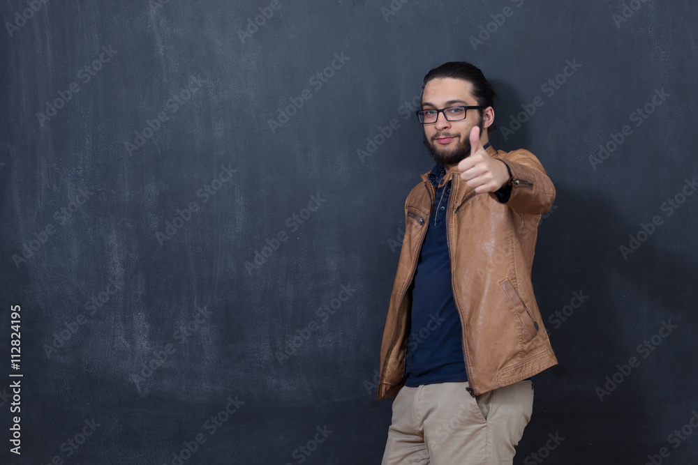 Attractive young man against blackboard. Attractive young man against blackboard.