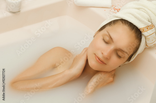 Girl with closed eyes in the bath photo