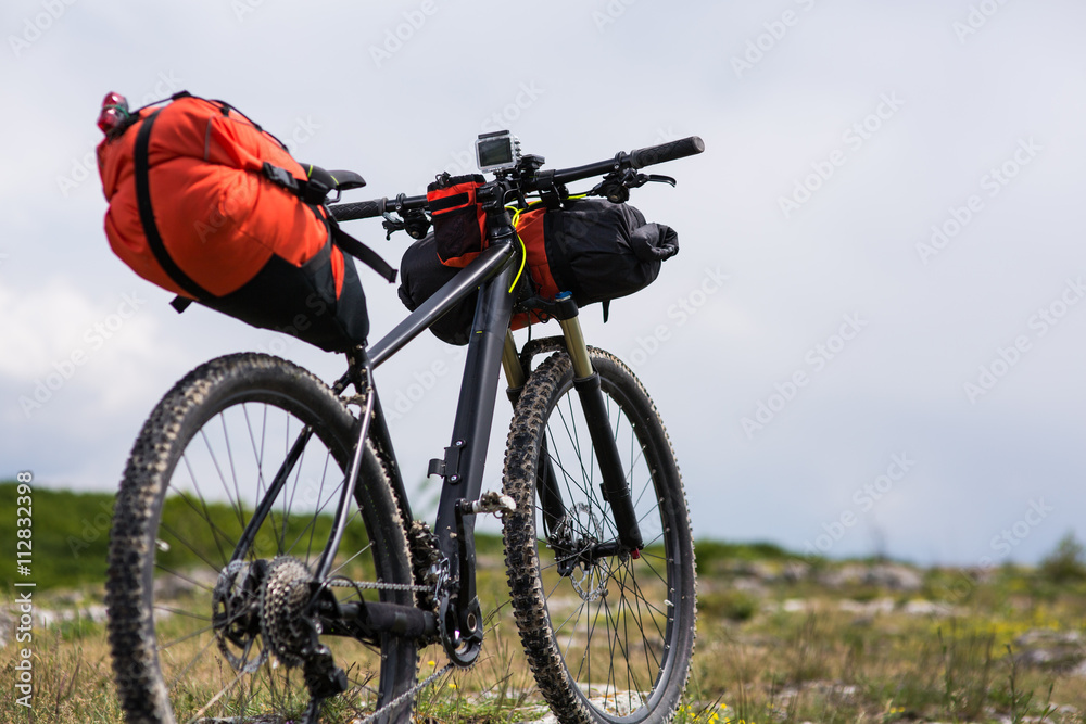 Bicycle with orange bags for travel Bicycle with orange bags for travel
