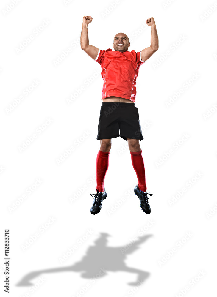 football player in red jersey jumping and screaming excited celebrating scoring goal