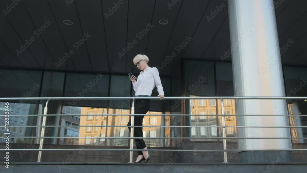 Young Beautiful Business Woman Making a Phone Call Outside Business Center