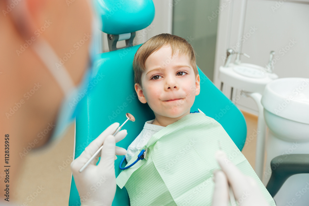 Scared boy sitting with mouth closed in dental clininc Scared boy sitting with mouth closed in dental clininc