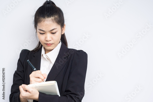 Asian woman in business black dress suit holding an office noteb photo