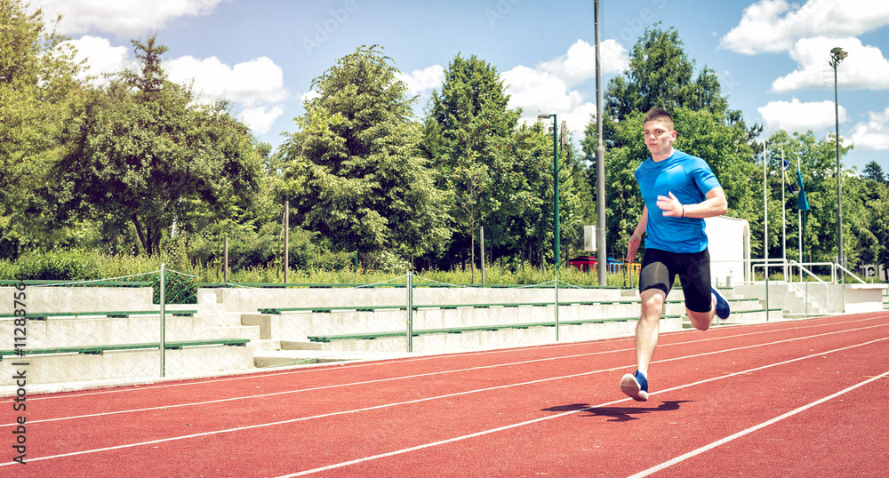 Running fast on athletic field track.