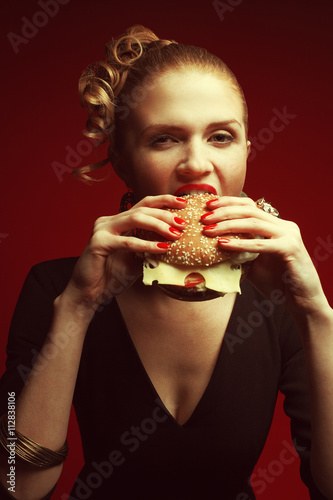 Fashion & Gluttony Concept. Portrait of luxurious red-haired model