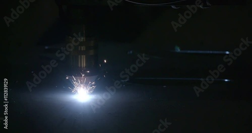 A plasma cutter cutting the big sheet inside the big steel factory photo