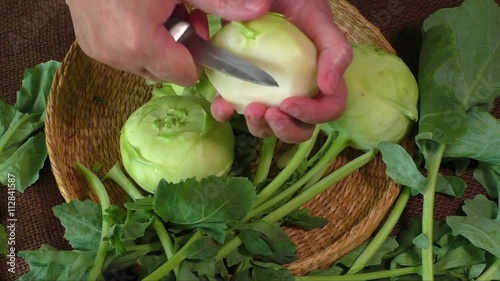 Fresh kohlrabi with knife on a wooden table 
 photo