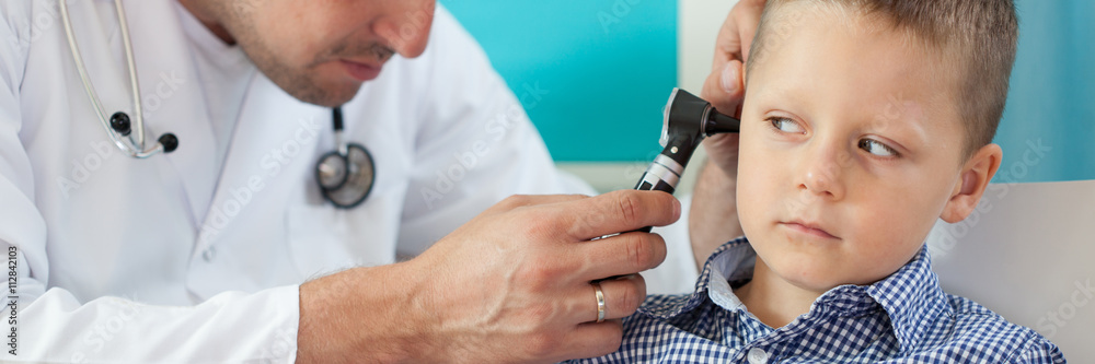 Fototapeta premium Pediatrician using otoscope