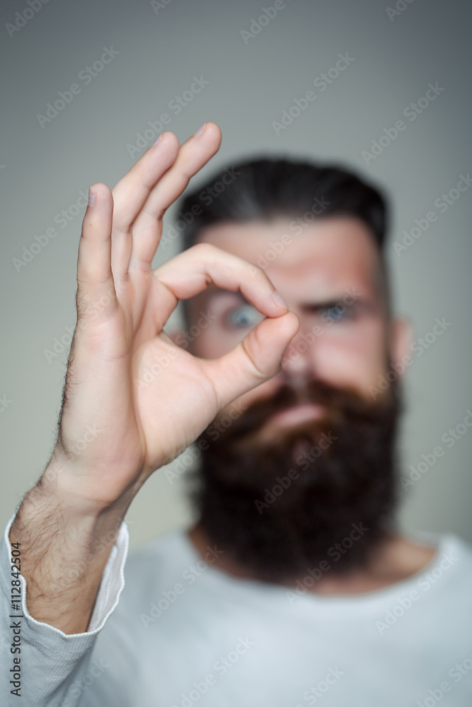 Bearded man with okey gesture