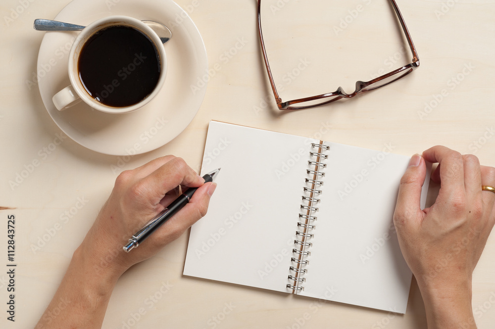 Small notebook and coffee cup