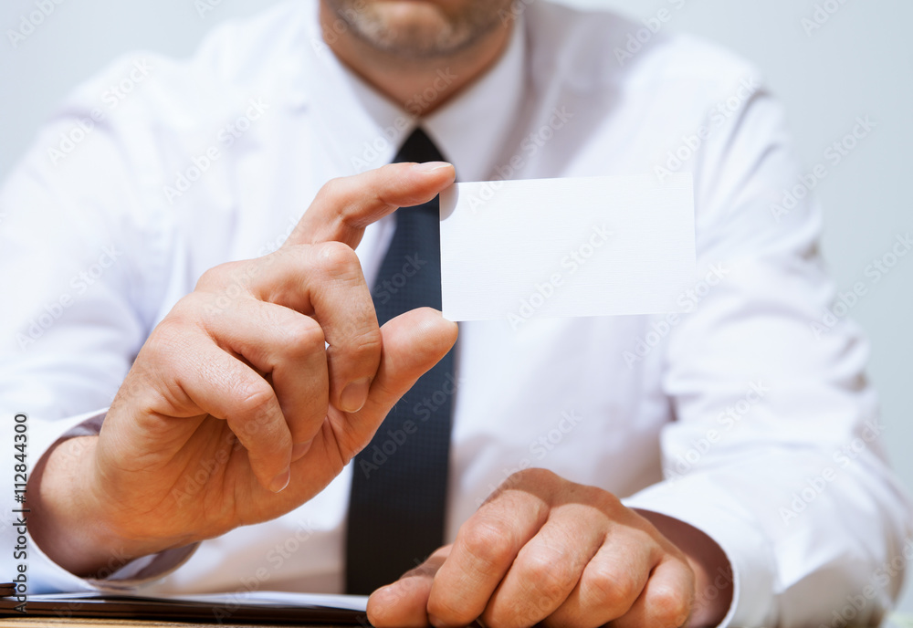Businessman holding a business card Businessman holding a business card
