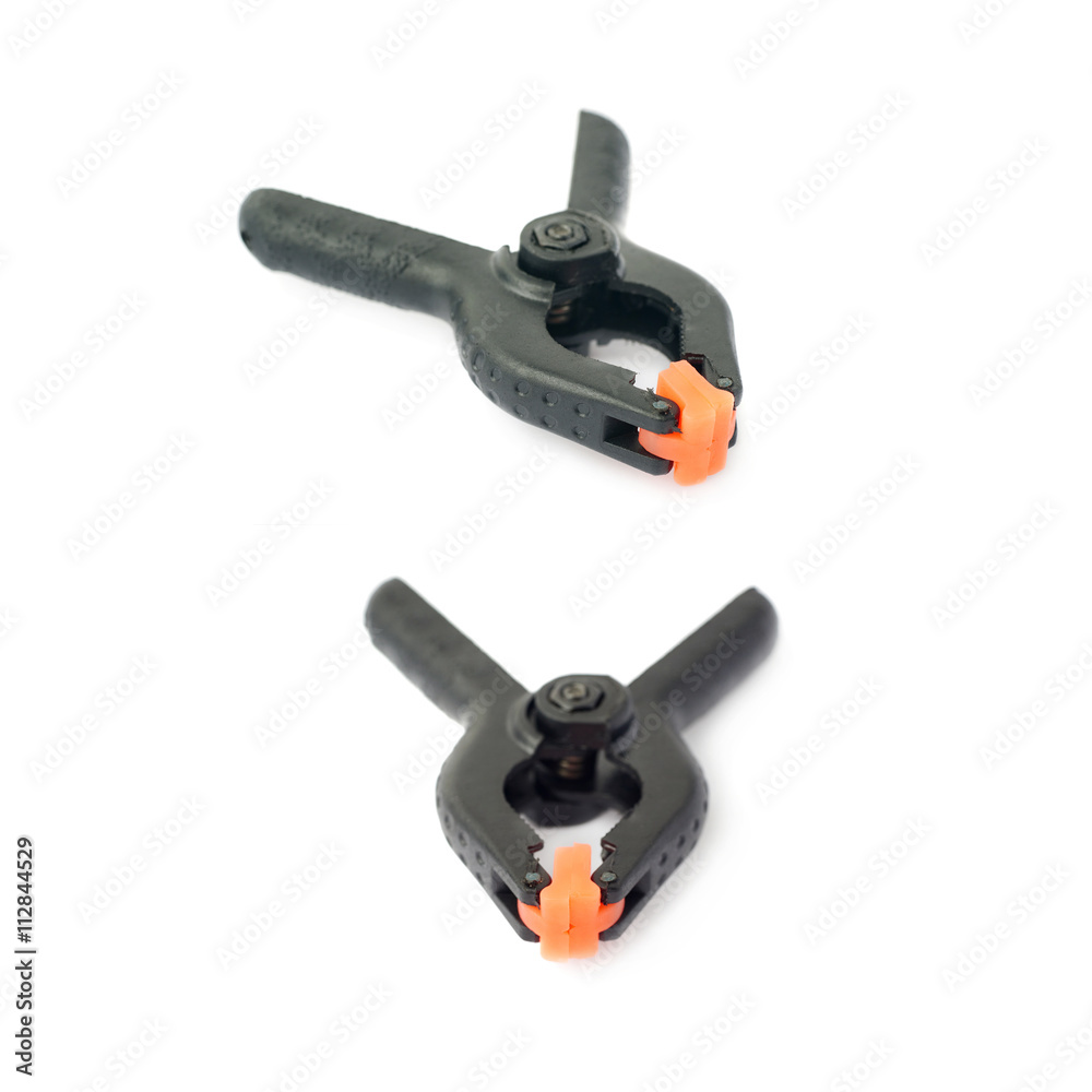 Set of Clamp with orange plastic jaws, isolated over the white background Set of Clamp with orange plastic jaws, isolated over the white background
