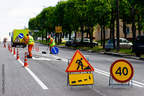 road works, painting of road lanes, selective focus on road sign