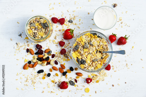 A healthy breakfast with cereal muesli, milk, nuts and berries