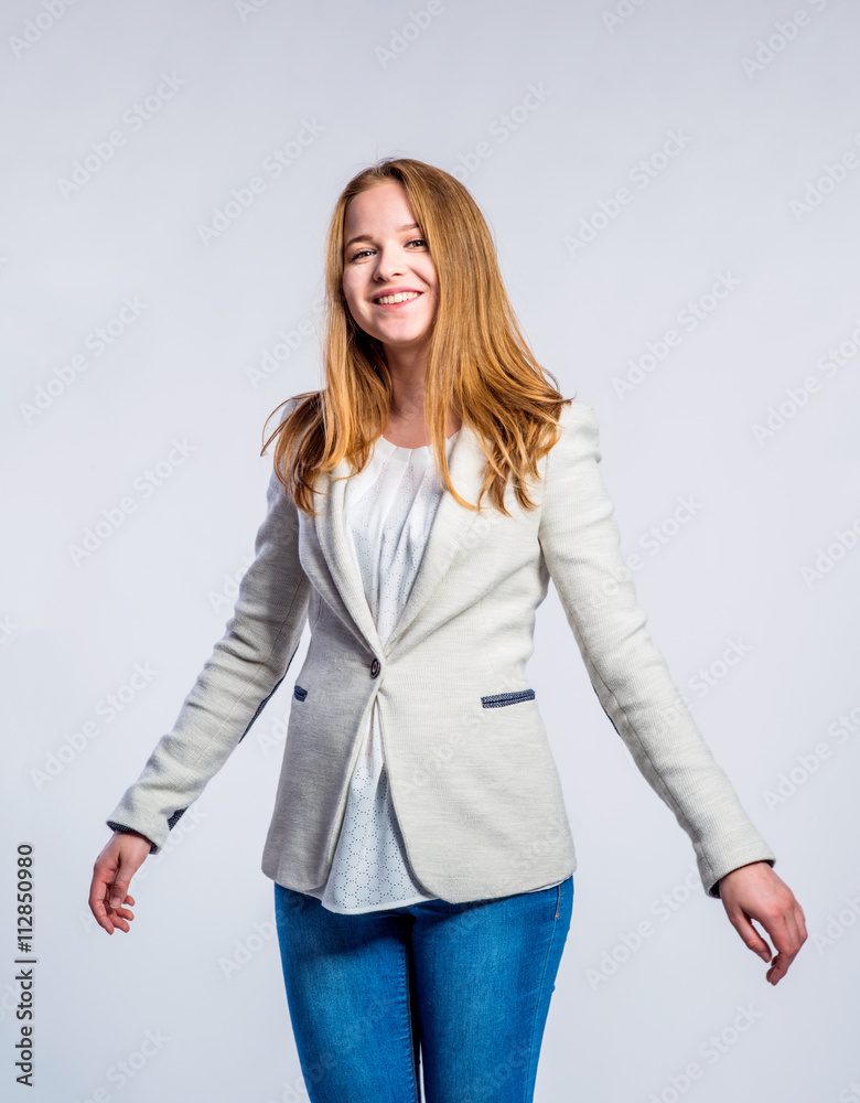 Girl in jeans and beige jacket, woman, studio shot Girl in jeans and beige jacket, woman, studio shot