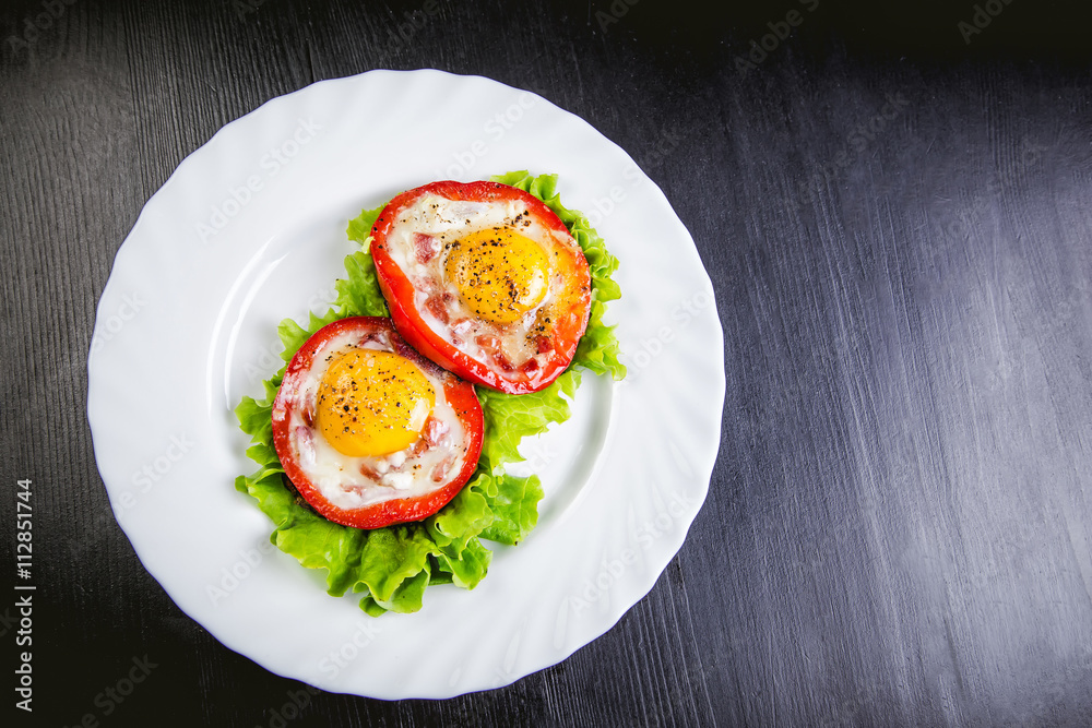 eggs on a green salad in a red pepper, food