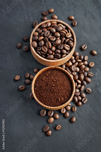 Coffee beans and ground coffee in a wooden bowl