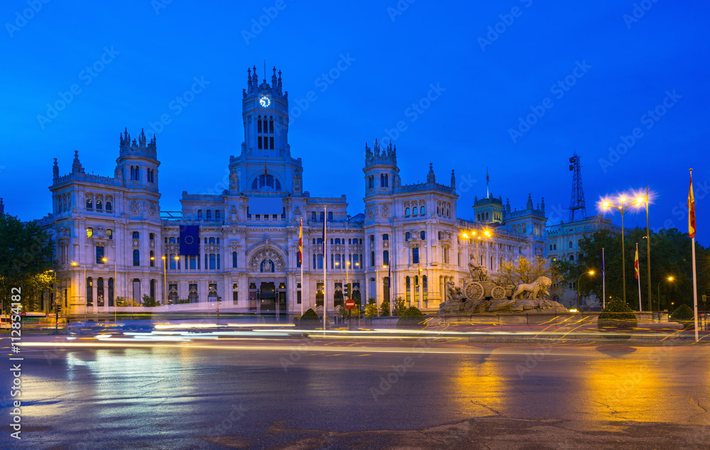 Night view of Cybele's Square (Plaza de la Cibeles) and Central Post Office (Palacio de Comunicaciones) in Madrid, Spain