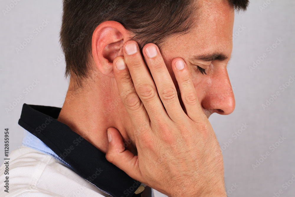 Man with a headache. Man with ear pain, Earache. Pain relief concept Man with a headache. Man with ear pain, Earache. Pain relief concept