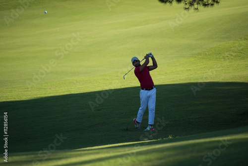 golf player hitting long shot