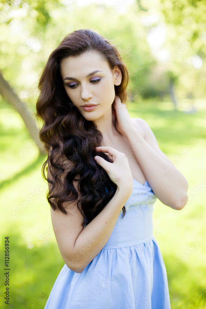 Portrait of a beautiful young Caucasian woman in a spring garden. Portrait of a beautiful young Caucasian woman in a spring garden.