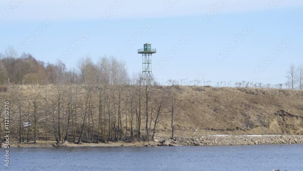 Zoom out view of the lighthouse from the lake in the Russian border in Narva Estonia Zoom out view of the lighthouse from the lake in the Russian border in Narva Estonia