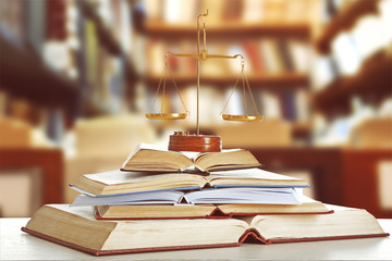 Justice scales on table in library