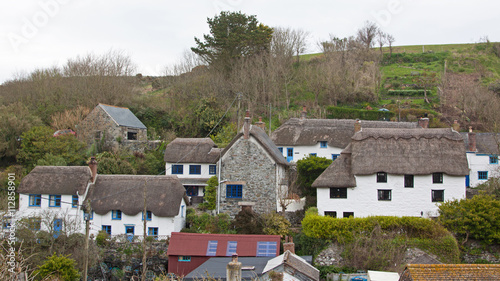 Traditional thatched houses in an ancient Cornish fishing village photo