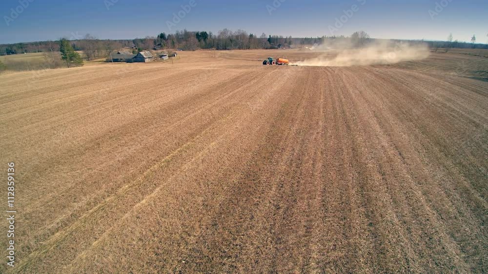 Big dust from the agriliming process in the field of the big farm Big dust from the agriliming process in the field of the big farm