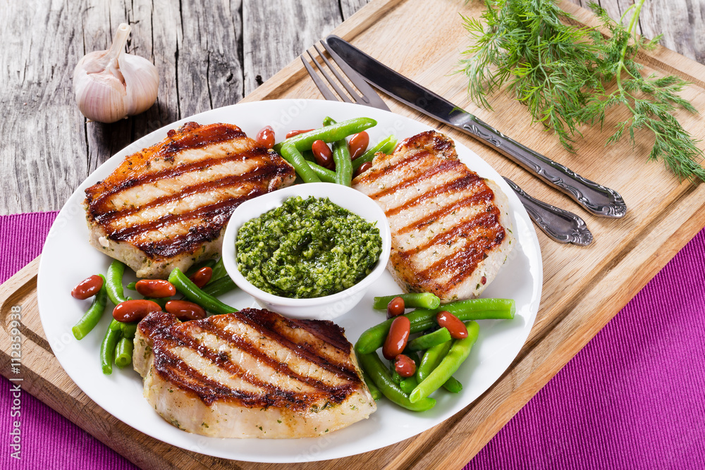 grilled pork chops on a white dish grilled pork chops on a white dish