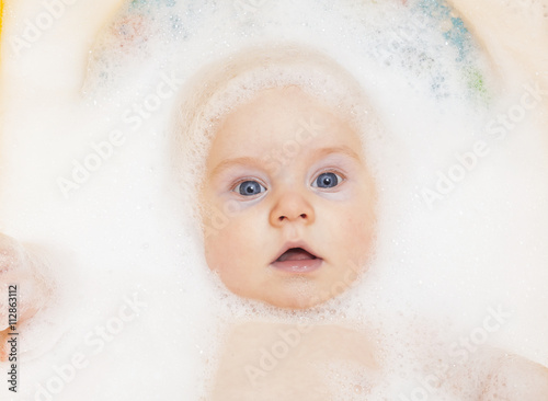 funny baby bathed in foam