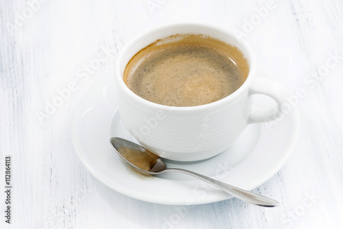 cup of black coffee on white wooden table