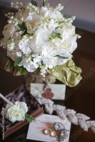 wedding bouquet of white small flowers lily-of-the-valley at girl's hand