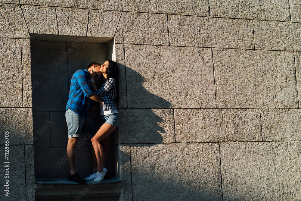 Fototapeta premium guys kissing standing in the window opening