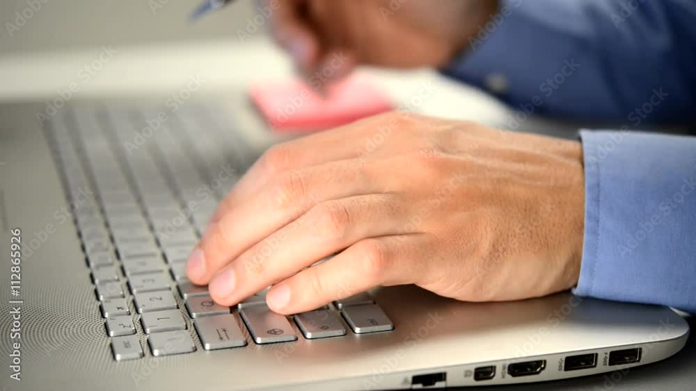 Businessman typing on a computer keyboard Businessman typing on a computer keyboard