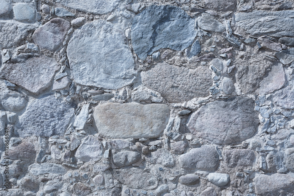 Old masonry wall of natural stones different sizes