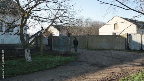 Male Walking Down Street Past Courtyards in the National Reserve photo