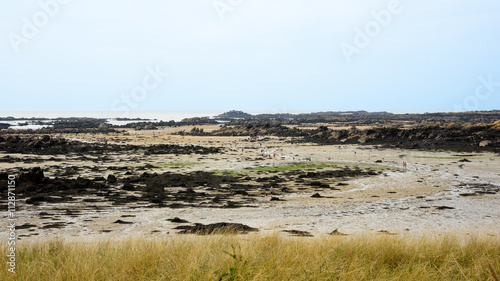 People walking in the low tide landscape of Iles de Chausey