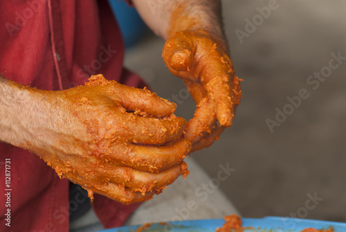 traditional home production of sausages on the island of Mallorca, Spain. hands full of sausage filling