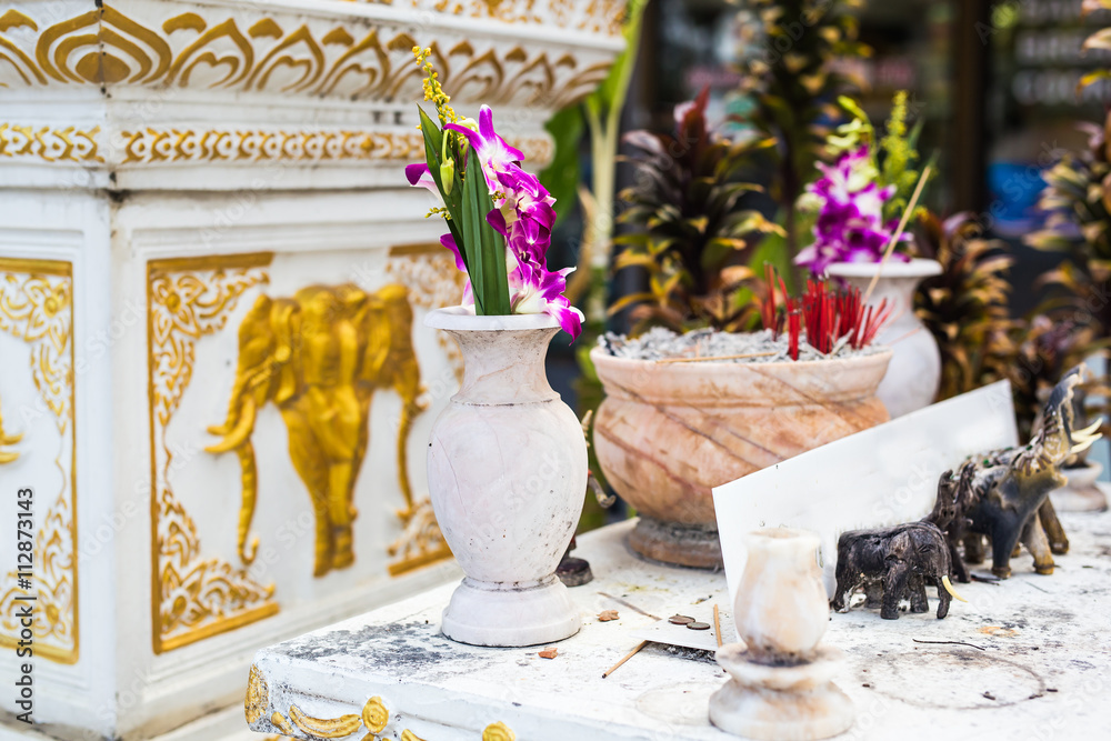 Outdoor spirit house in Thailand. garland and some wreathes, joss house.