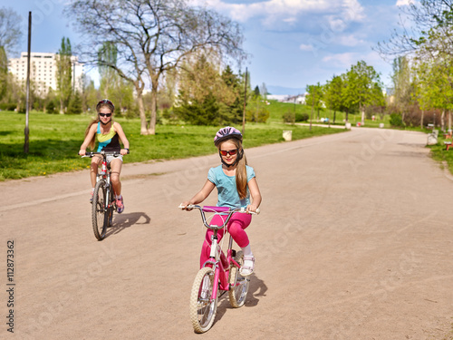 Bikes cycling girl. Girl rides bicycle in park. Girl in cycling riding on bicycle lane . Cycling is good for health. Cyclist looking at camera.